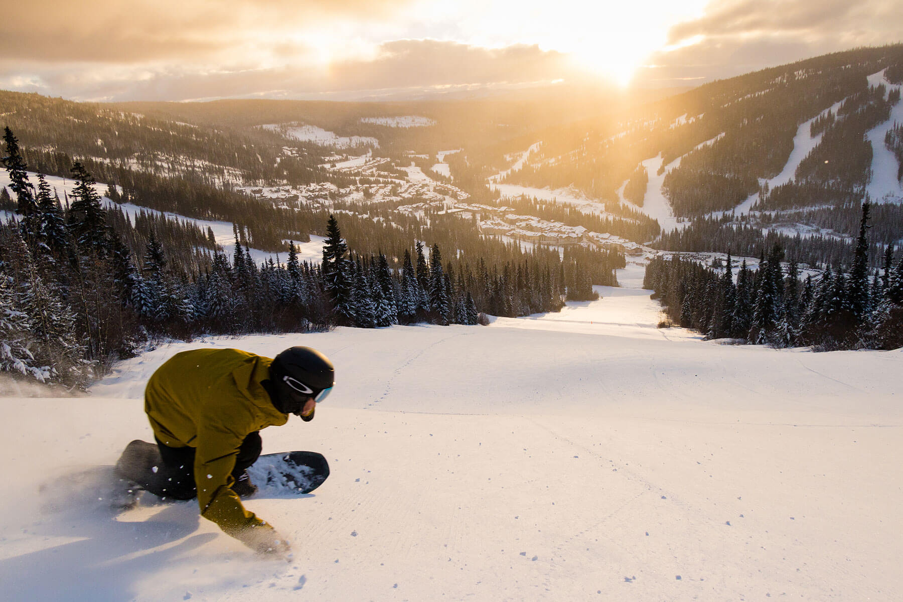 Snowboarder, snowboarding down Exhibition at Sun Peaks Resort BC